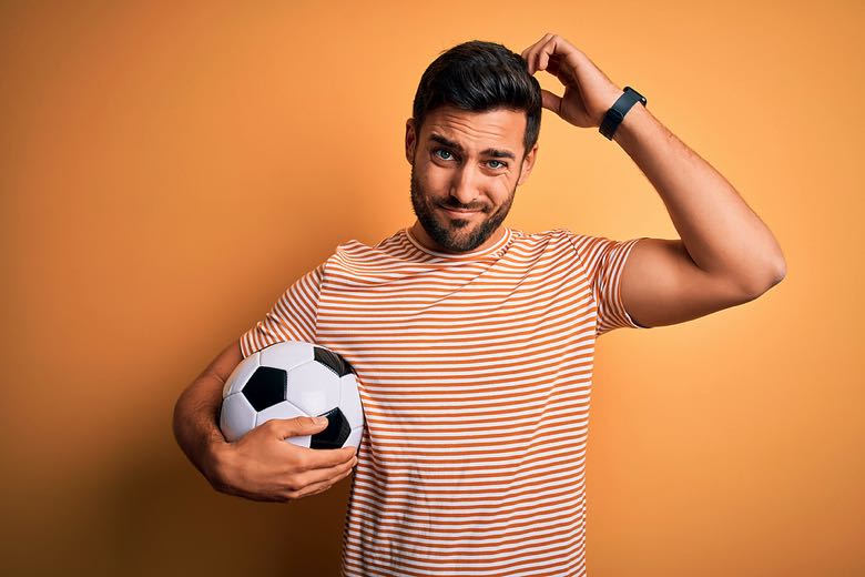 confused-man-with-soccer-ball